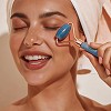 Woman applying skincare on her face
